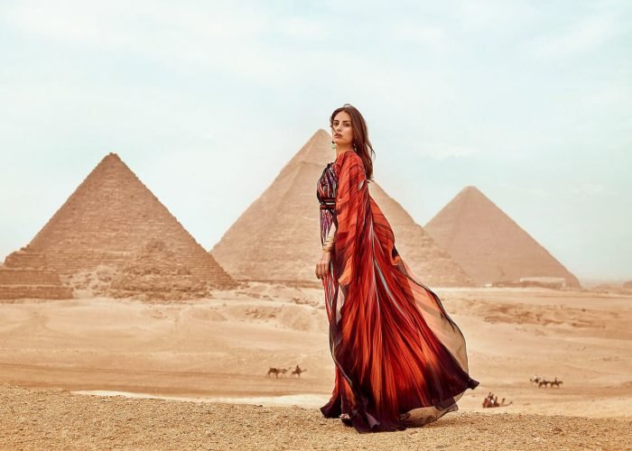 A-wonderful-picture-of-a-girl-wearing-a-red-dress-standing-in-front-of-the-pyramids
